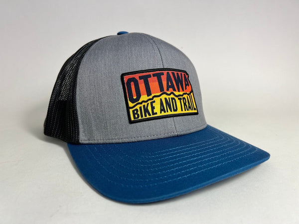 Ottawa Bike and Trail, LLC Shop Merch OBAT Logo Sunrise Trucker Hat